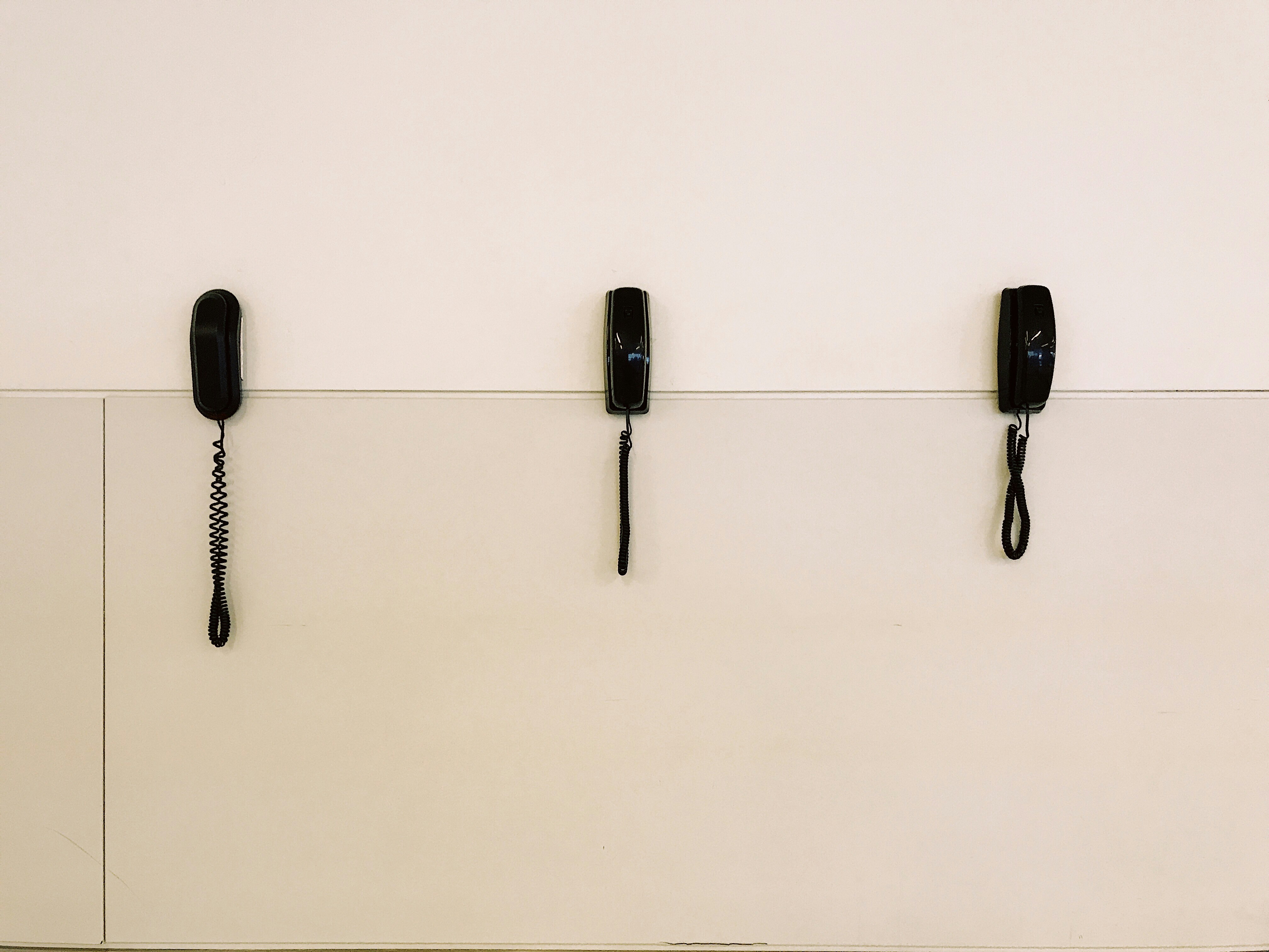 three black telephones